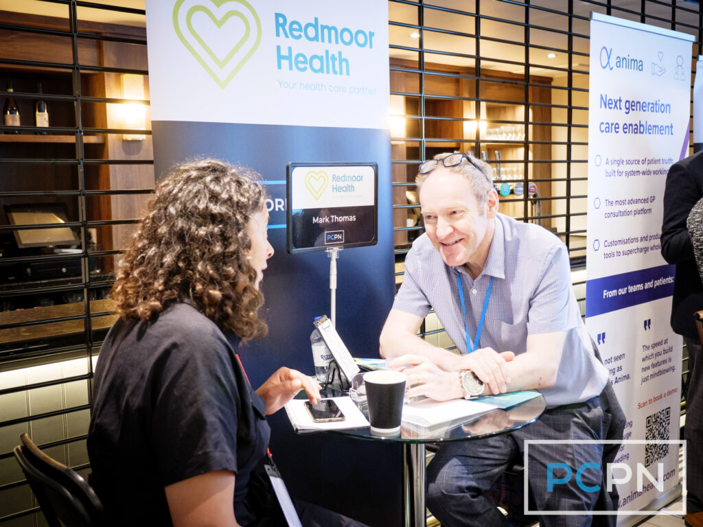 Mark Thomas from Redmoor health in a business meeting with a delegate